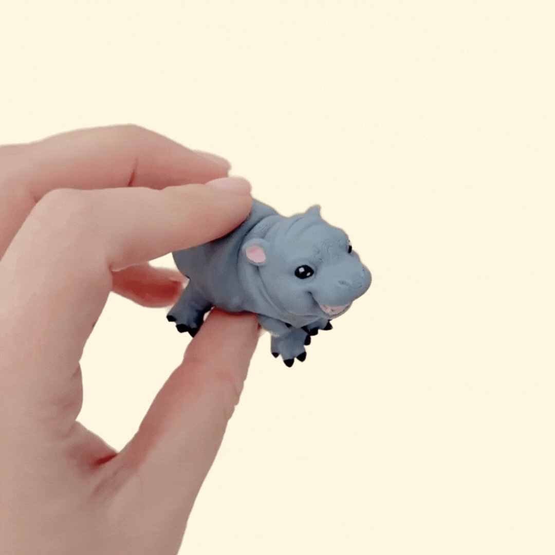 Small hard plastic baby hippo fidget toy for sensory play
