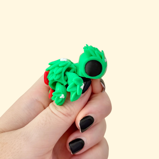 Small festive turtle-shaped fidget toy with textured surface
