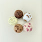 Small muffin-shaped fidget with a clickable centre and realistic dessert-style textures for sensory play.