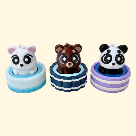 Cute bear clicker fidget sitting in a textured bath tub with a push-down click mechanism.
