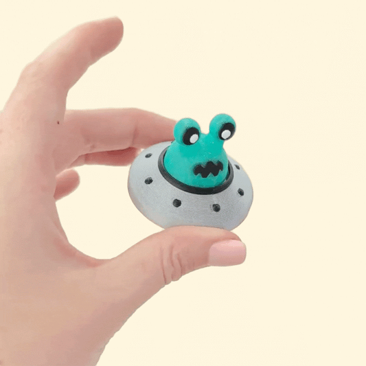 Compact 5 cm saucer with black port details for desktop fidgeting.
