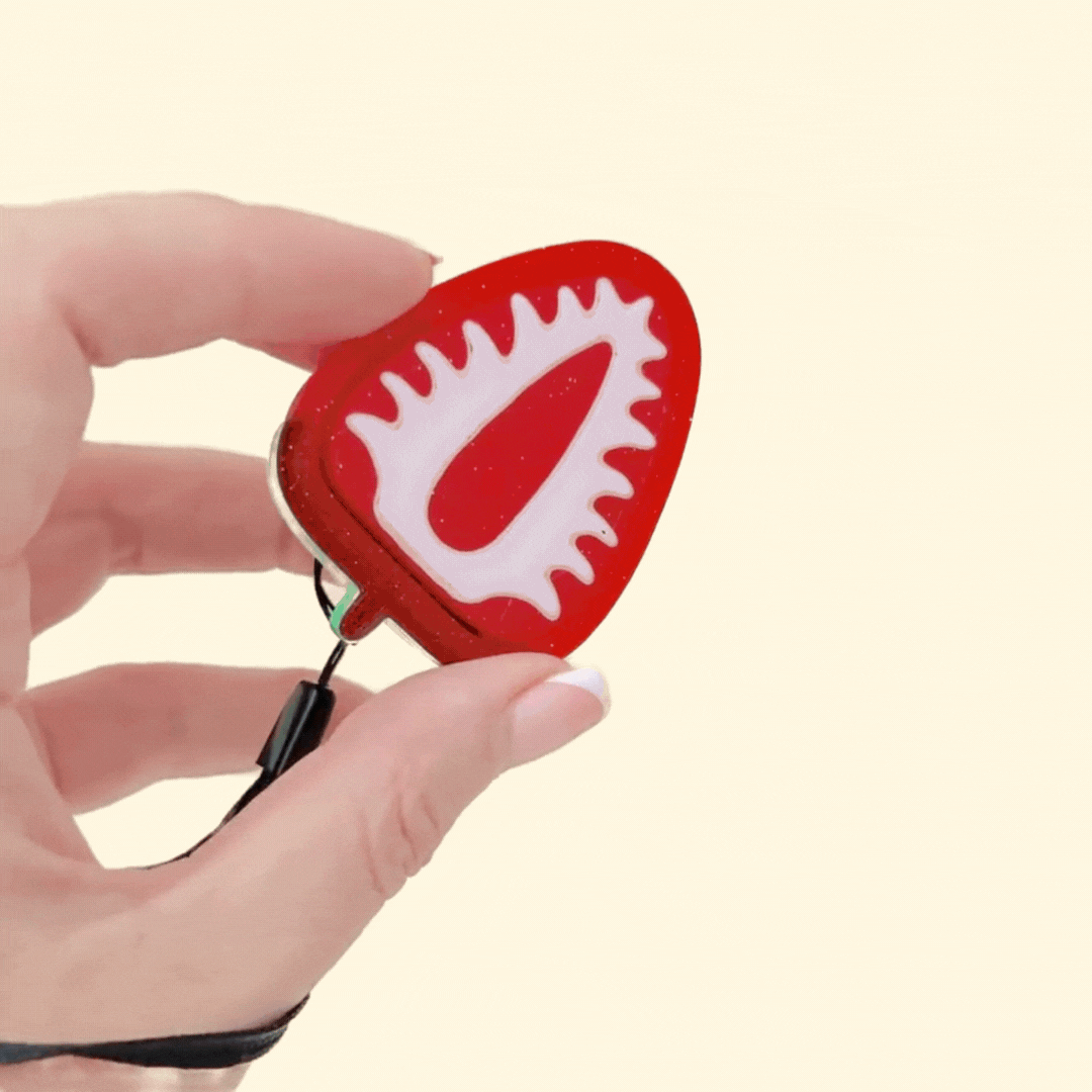 strawberry slice clicker fidget toy with glittery finish and tactile raised seeds
