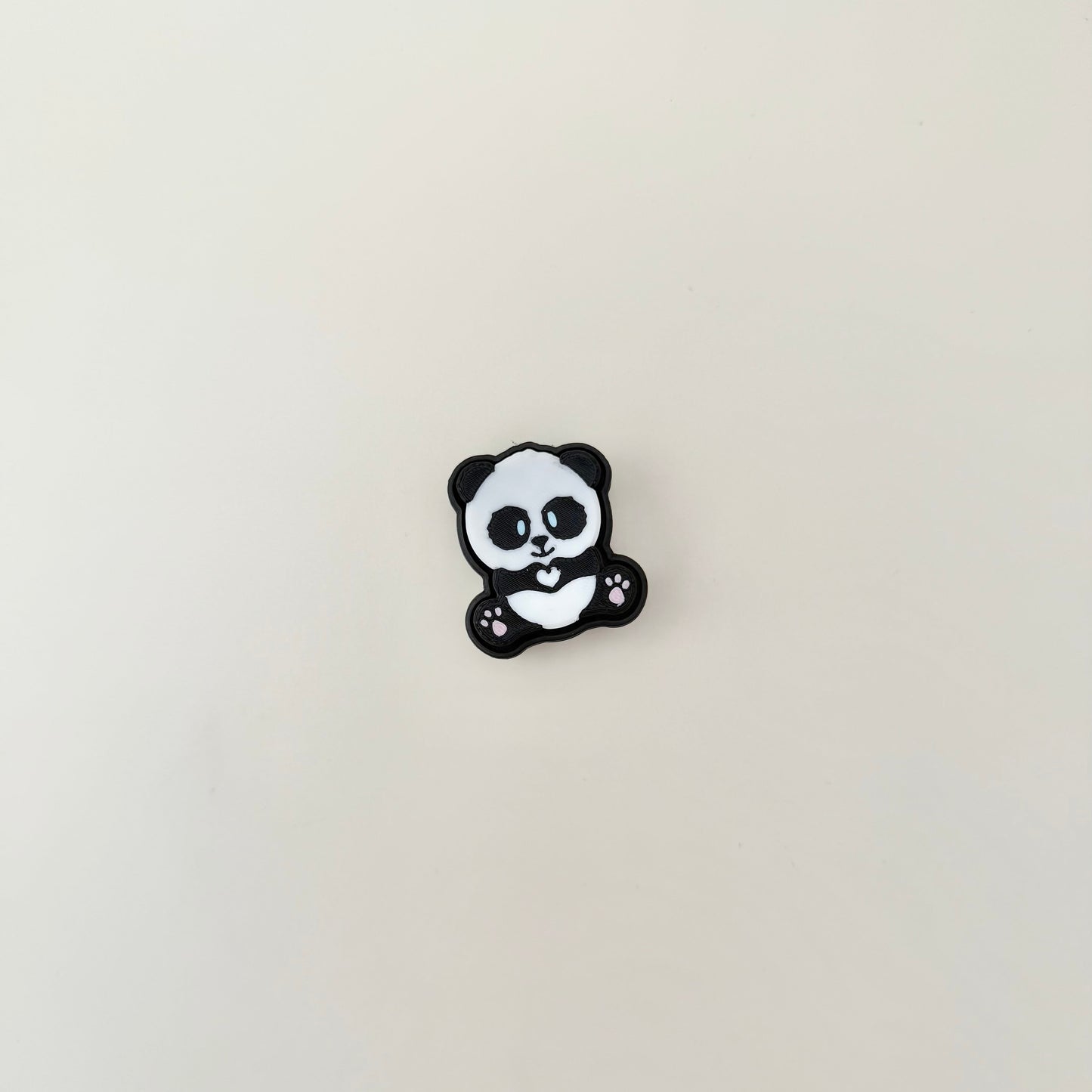 Compact panda-themed click button toy with rounded edges and soft click for light sensory input.