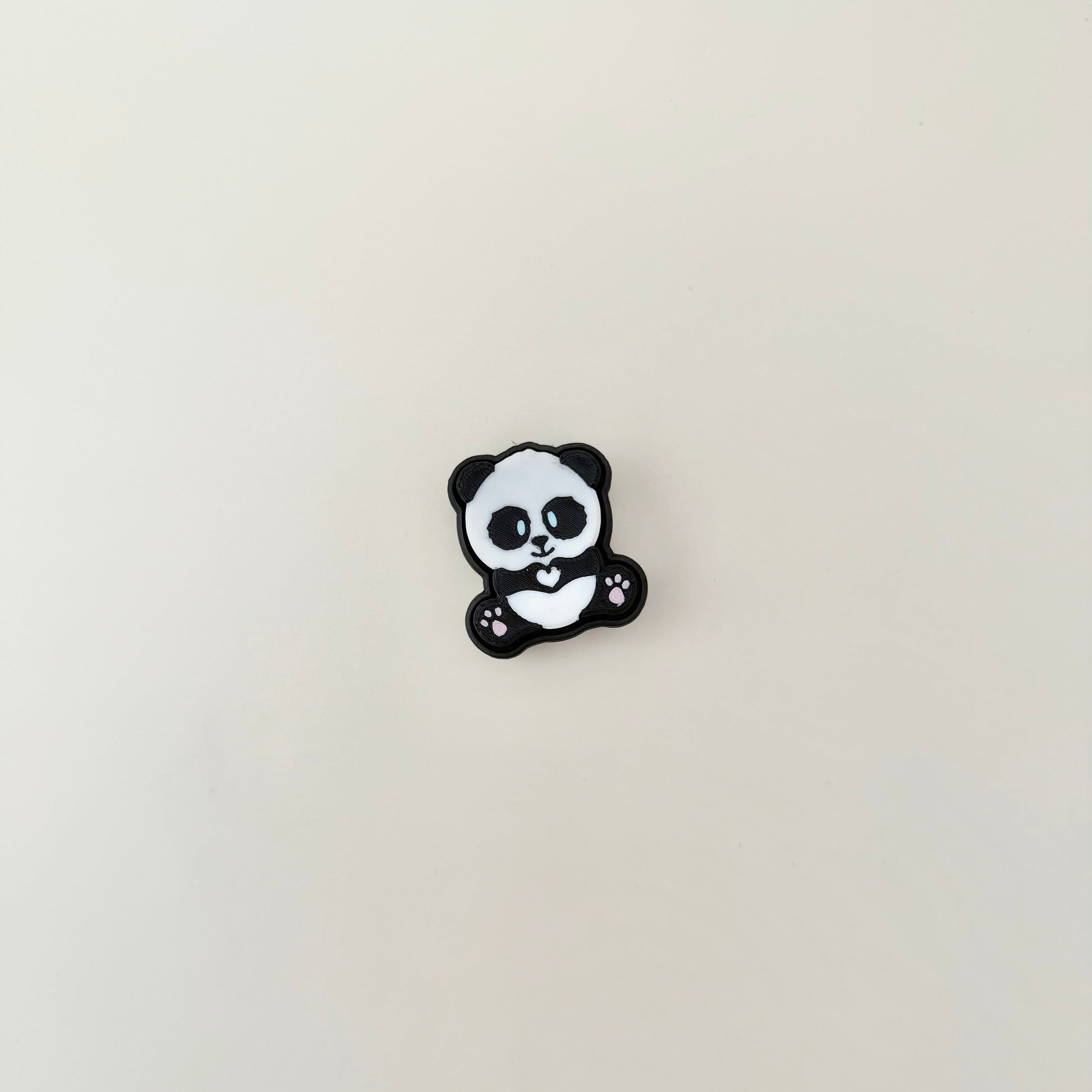 Compact panda-themed click button toy with rounded edges and soft click for light sensory input.