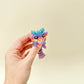 Limited edition rainbow dragon fidget toy with translucent colour and articulated body for sensory regulation.