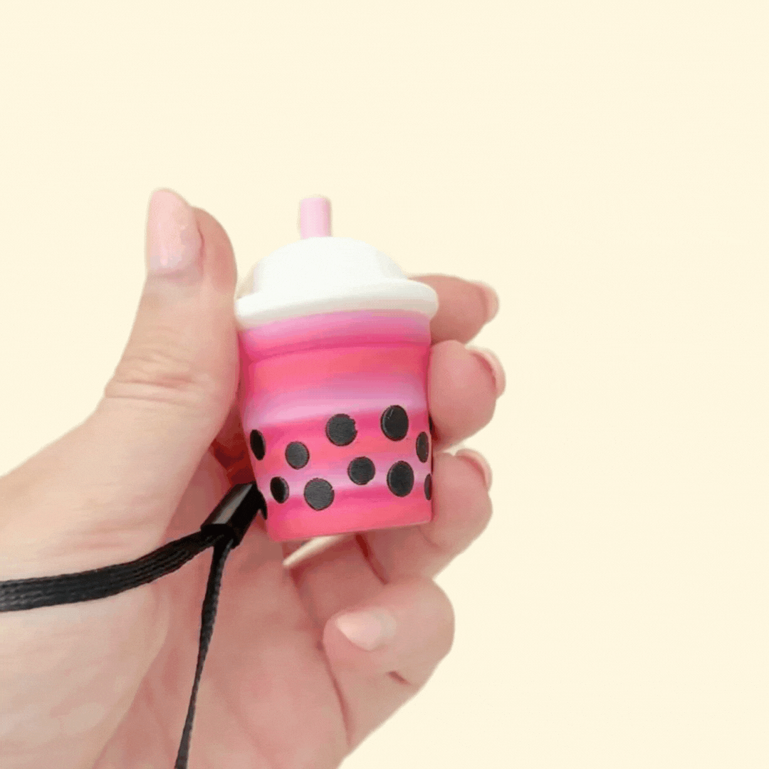 Drink-shaped fidget clicker with a smiley face or domed lid, designed for tactile stimming.