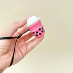 Colourful boba-themed clicker designed for palm stimming and everyday fidgeting.