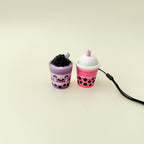 Chunky bubble tea fidget toy with pressable top and strap for easy carrying.