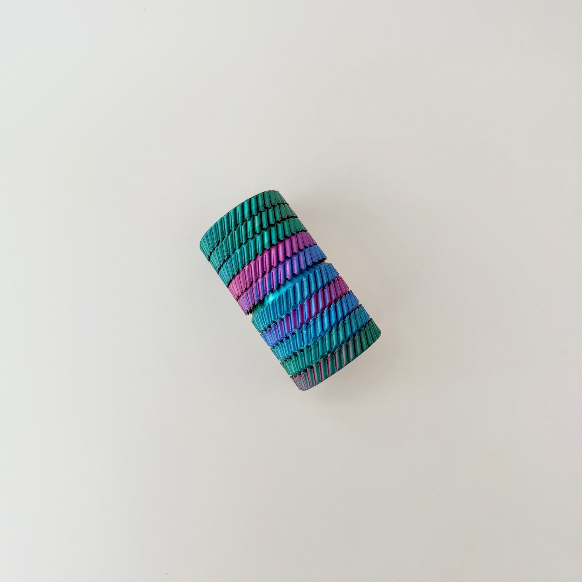 A unique fidget toy in rainbow colours with interactive spinning and twisting features.