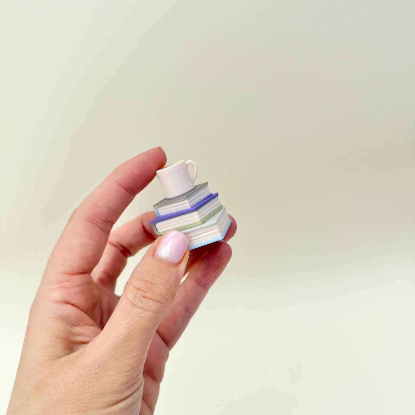 Stack-of-books clicker with cup; everyday carry fidget, optional quiet click, smooth and ridged textures for sensory regulation.