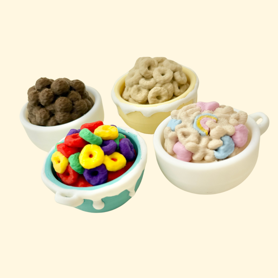 Mini cereal bowl fidget with mix-and-match toppings and keyring loop for portable clicking.
