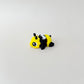 A small, flexible bee fidget toy with a cheerful face and a compact, pocket-friendly design.
