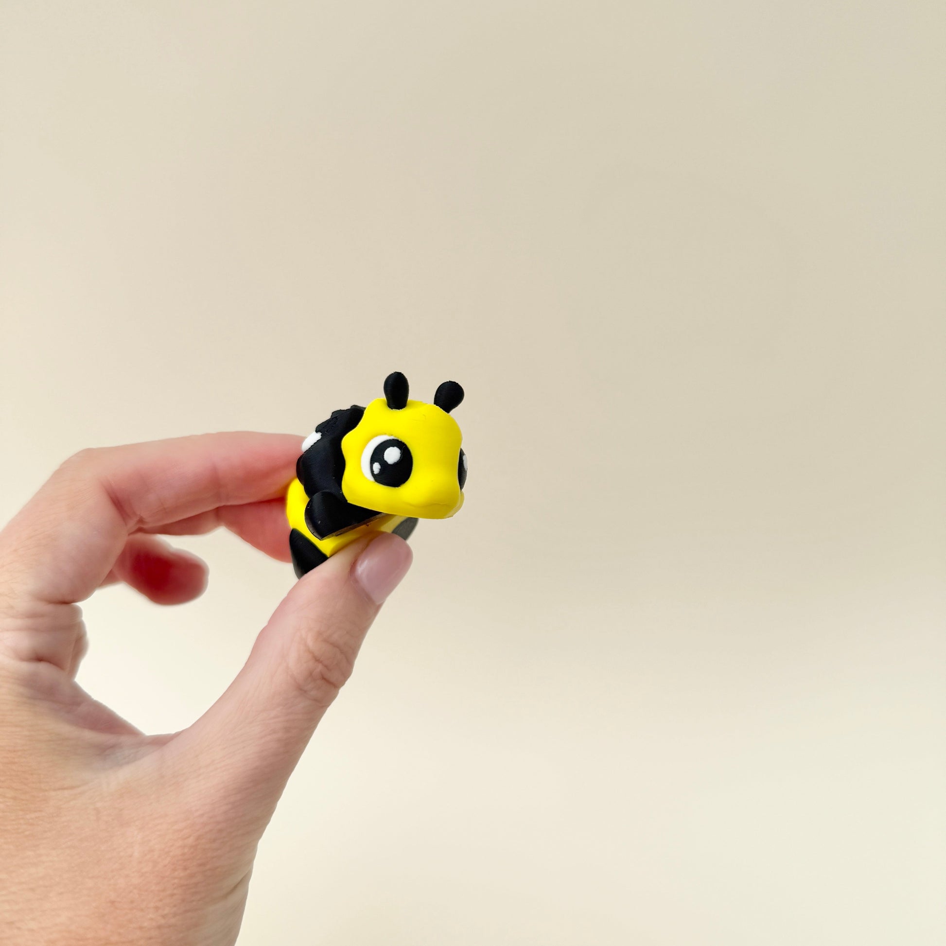 A cute fidget toy shaped like a bee, complete with white wings and a fully flexible body.