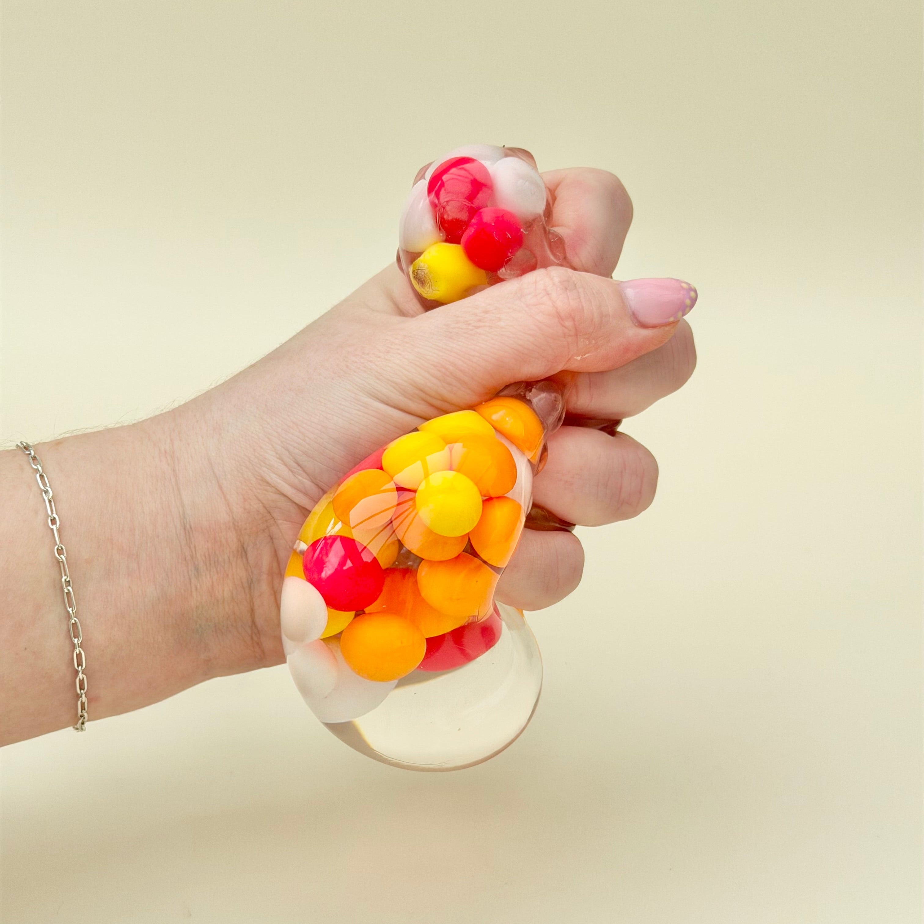 Quiet squishy sensory fidget with raised texture and visual movement inside, ideal for desk resets and travel use.
