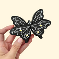 Sensory fidget toy with monochrome butterfly design and raised detailing