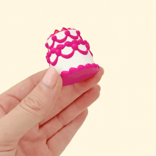 birthday cake clicker fidget toy with textured tiers and strawberries on top
