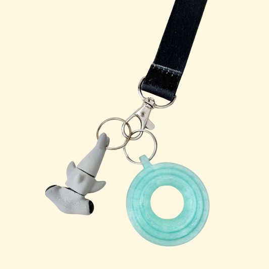 Smooth sensory lanyard add-on with gentle movement along the body for subtle stimming without noise.
