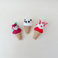 Festive cone clicker with bold red-white elements and rounded sprinkles, designed for tactile feedback and firm click.
