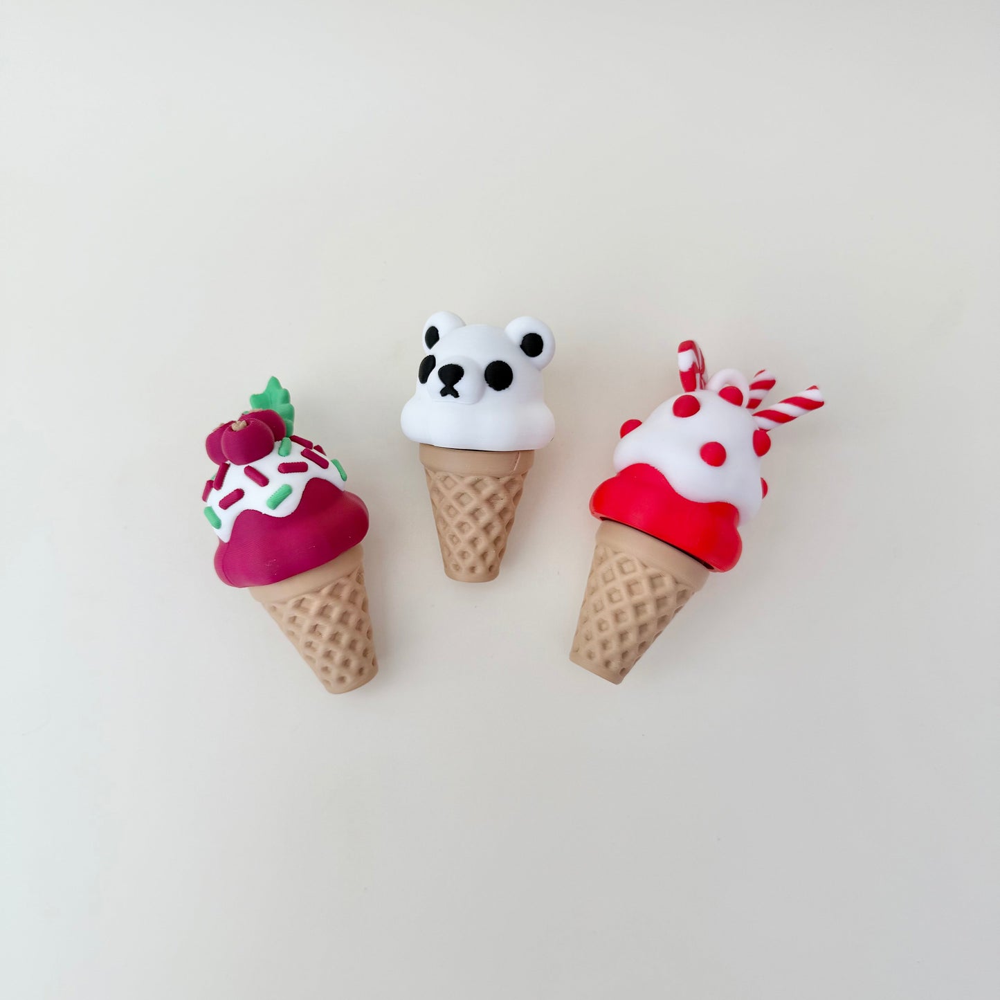 Festive cone clicker with bold red-white elements and rounded sprinkles, designed for tactile feedback and firm click.
