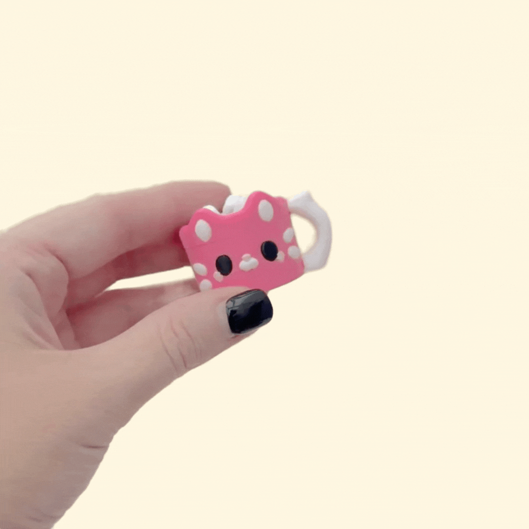Mini pink hot chocolate fidget with smooth cup and rounded marshmallow click section.
