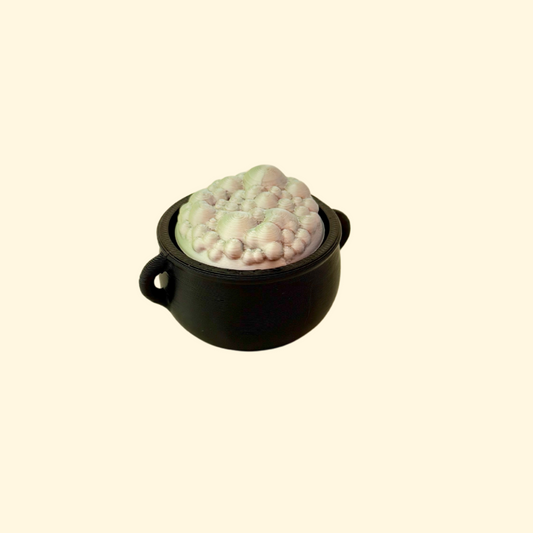 small cauldron-shaped clicker fidget with bubble details
