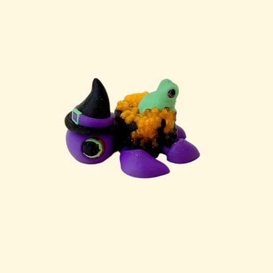 Halloween-themed turtle fidget toy designed with a witch hat, cauldron and textured details
