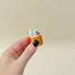Humorous cat clicker; sturdy 3D-print, clicky feedback, calming hand fidget for neurodivergent users and collectors.
