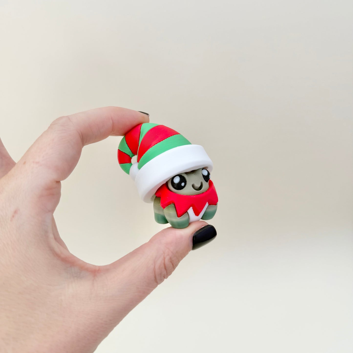 Winter-themed frog clicker for sensory regulation and focus; press-to-click mechanism.
