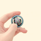 Mini 3.5cm diameter fidget spinner with a vibrant rainbow finish and full gyro spinner rings.