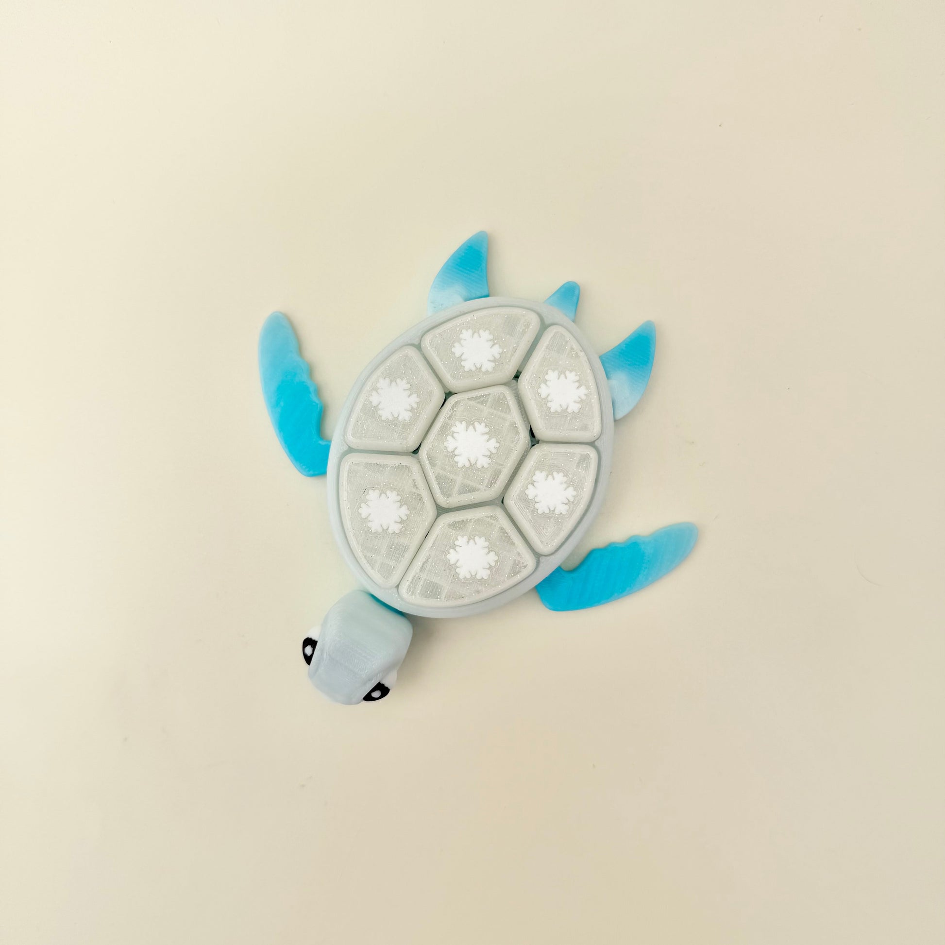Winter-themed turtle fidget toy with textured shell and smooth body for tracing.
