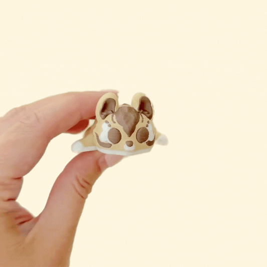 cute palm-sized sensory toy with gentle ridges for thumb tracing
