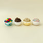Palm-size clicker with raised chocolate cereal balls and smooth bowl finish.
