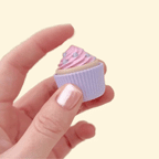 Handheld chocolate cupcake clicker featuring gold sprinkles, ideal for on-the-go fidgeting.