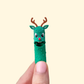 A novelty green pickle character with antlers and gentle articulation designed for light fidgeting.
