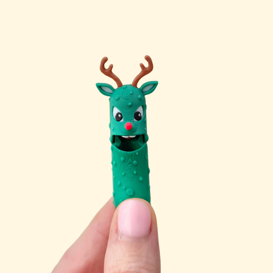 A novelty green pickle character with antlers and gentle articulation designed for light fidgeting.
