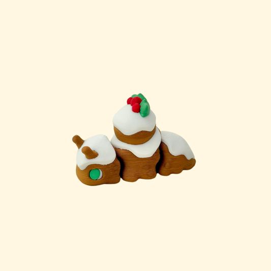 Pudding-brown articulated snail with white frosting and holly topper.
