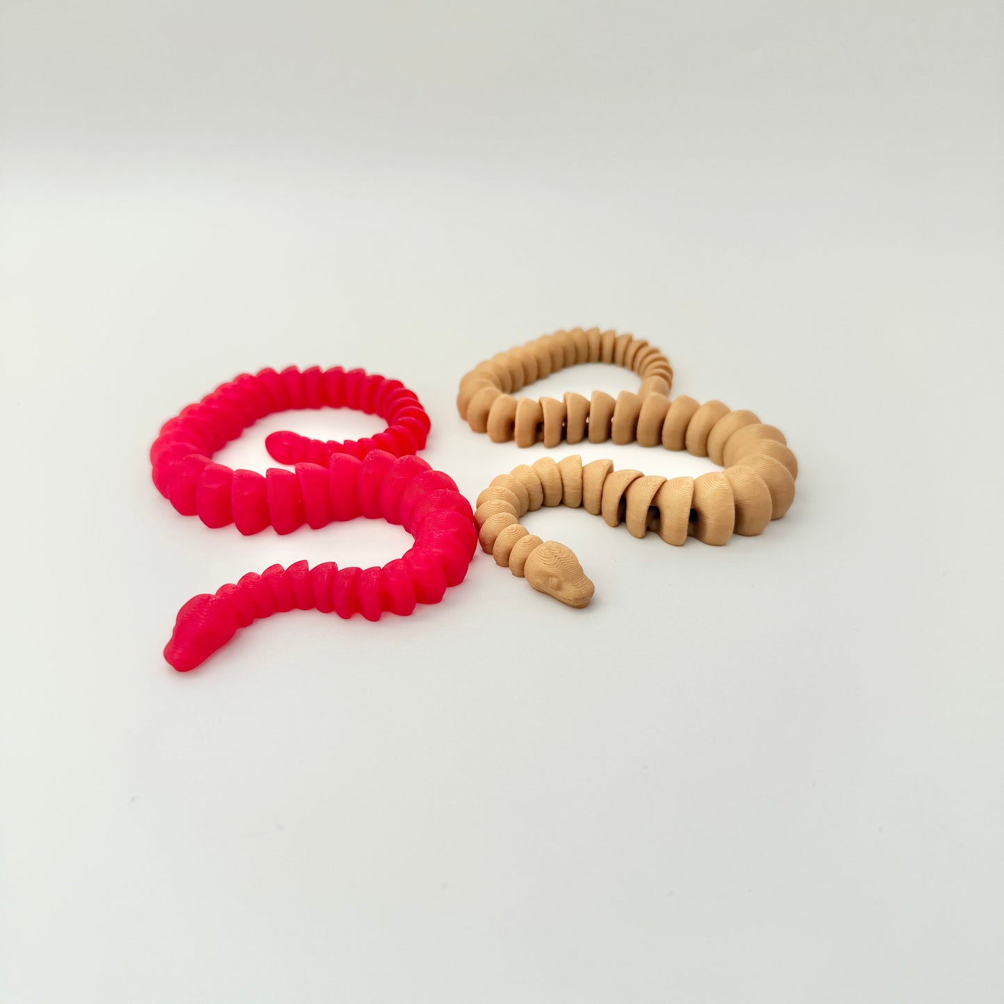 Handheld articulated snake for anxiety relief and stimming.
