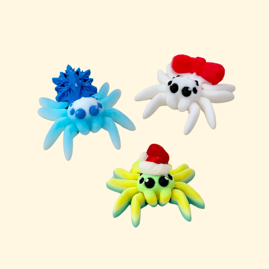 Small articulated spider toy with festive detailing for sensory play.
