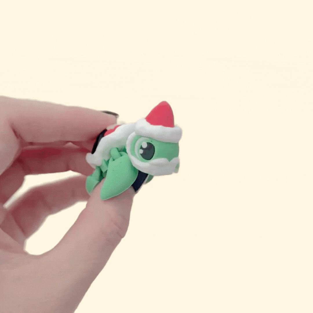 Compact articulated turtle with Santa-style shell, suitable for festive sensory play.
