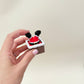 Small Christmas clicker, 5 cm, chunky feel with tactile edges; fun seasonal sensory tool and stocking filler.
