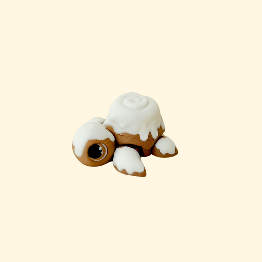 Articulated turtle fidget with a raised swirl “icing” shell for sensory tracing and stimming.
