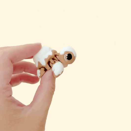 Small pastry-style turtle fidget with smooth glaze and textured details for tactile play.
