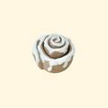 Cinnamon roll-inspired fidget clicker with swirled design and white icing.