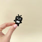 Black glitter keyring clicker with white panel; moderate click.
