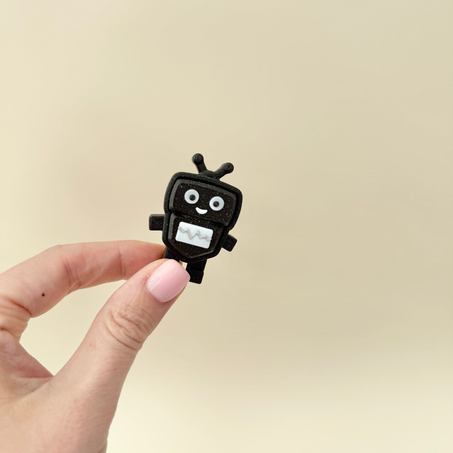 Black glitter keyring clicker with white panel; moderate click.
