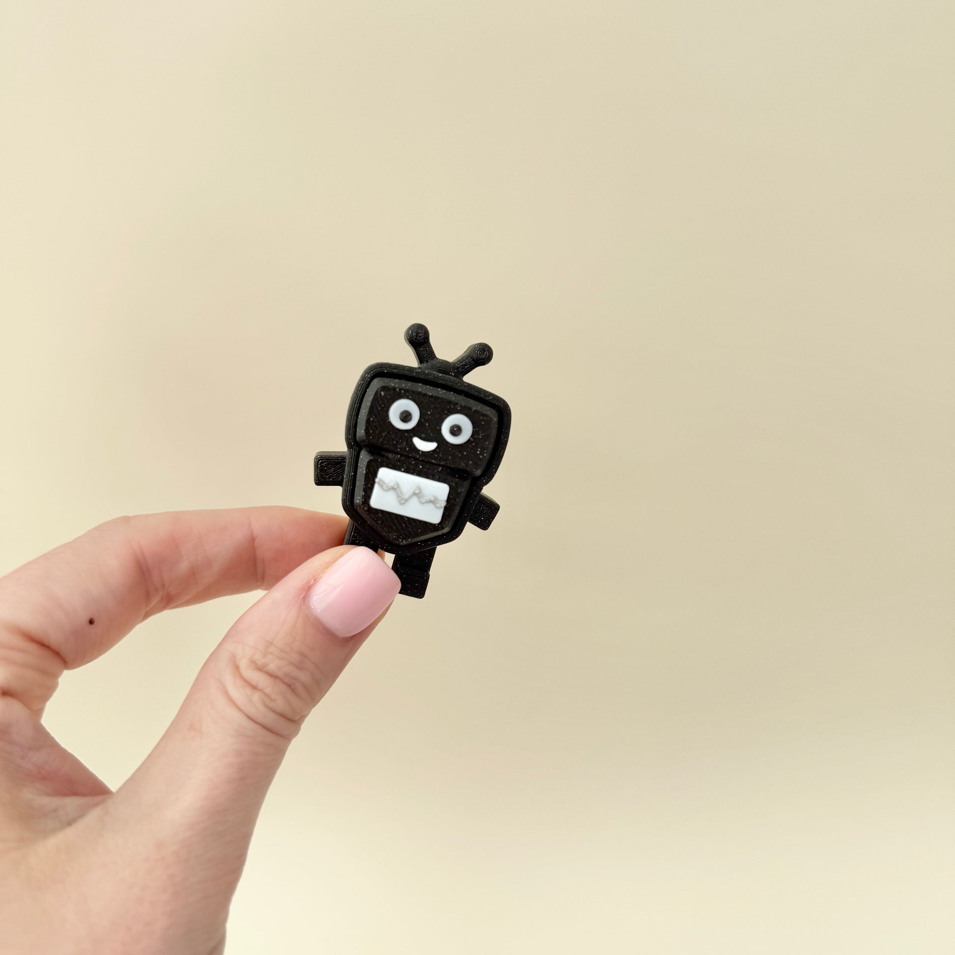 Black glitter keyring clicker with white panel; moderate click.

