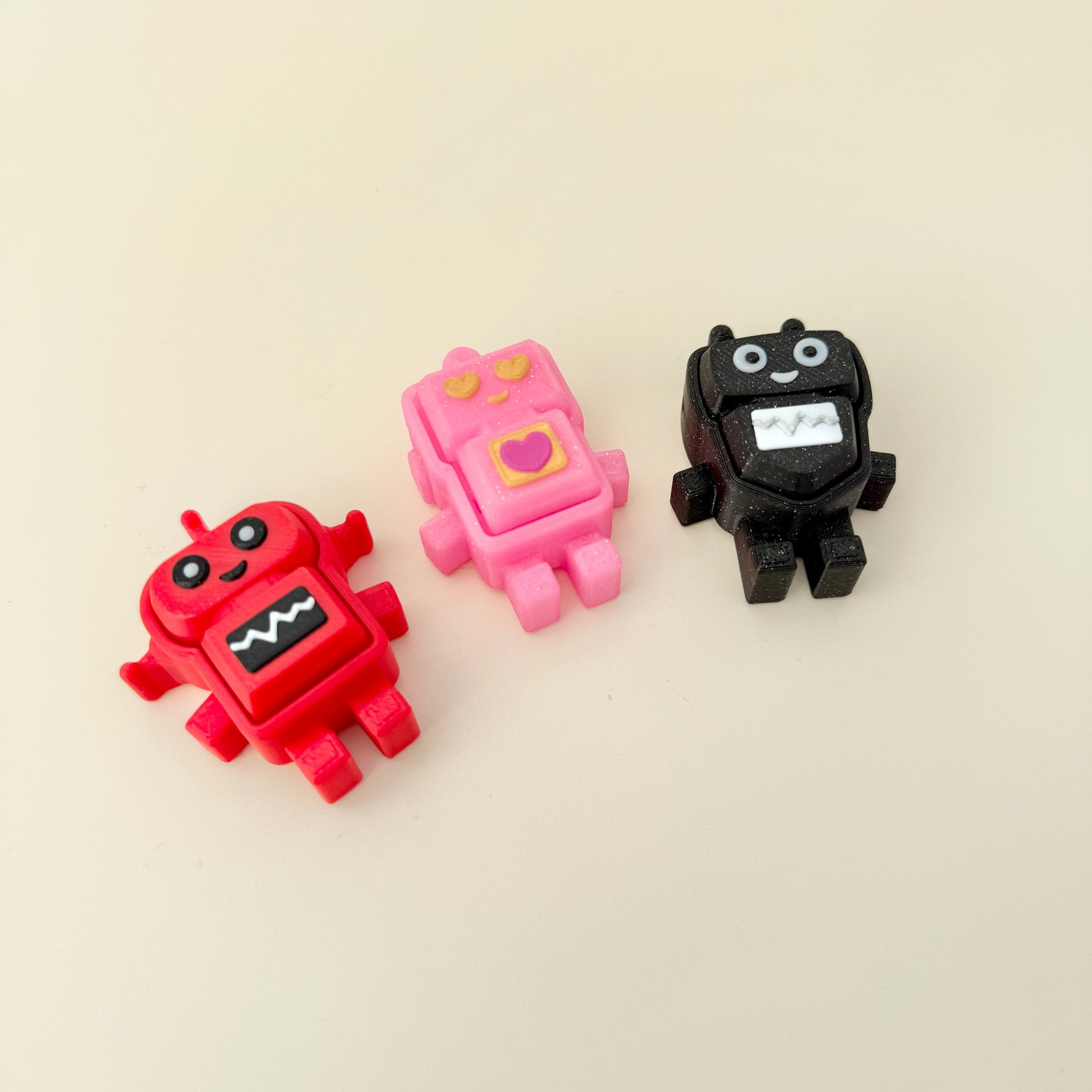 Small robot fidget with built-in loop for bags, lanyards, and keys.
