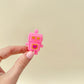 Sparkly pink glitter keyring clicker with a heart detail.
