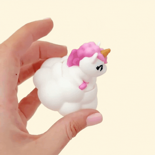 Palm-size cloud clicker with a pastel unicorn figure on top.
