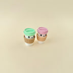 A compact coffee-themed fidget toy with a soft sleeve and colourful lid options.